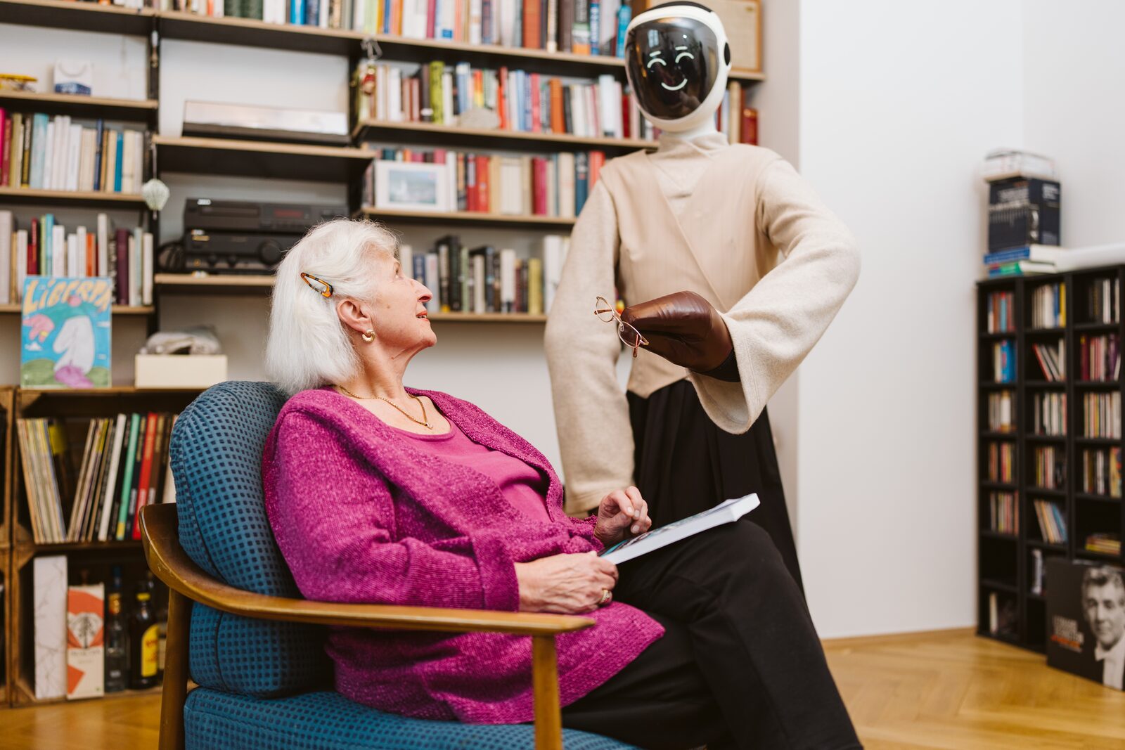 Robody handing glasses to a happy senior